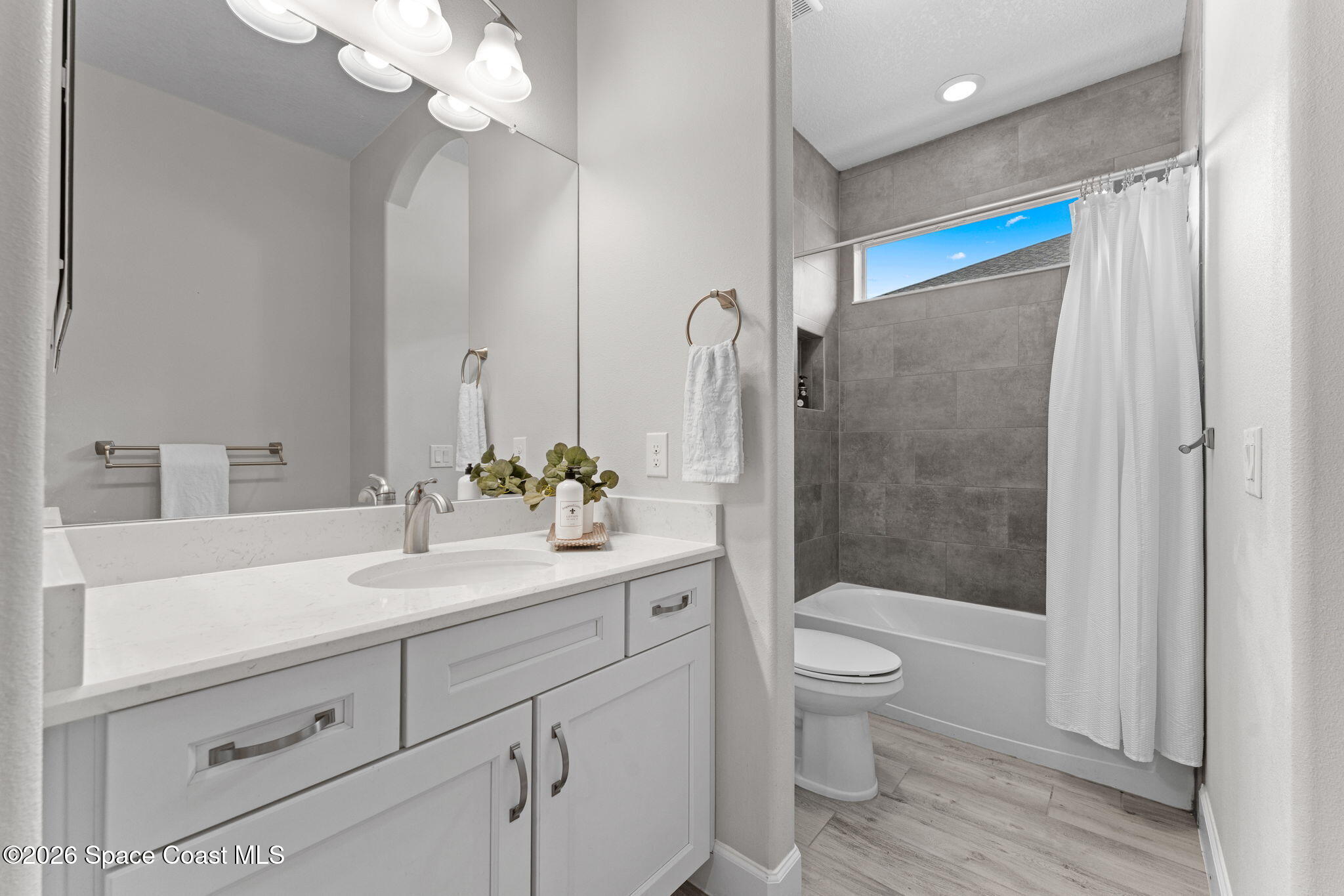 3158 Addison Drive Melbourne, FL 32940 - Photo 31 of 51 a bathroom with a sink a toilet and shower