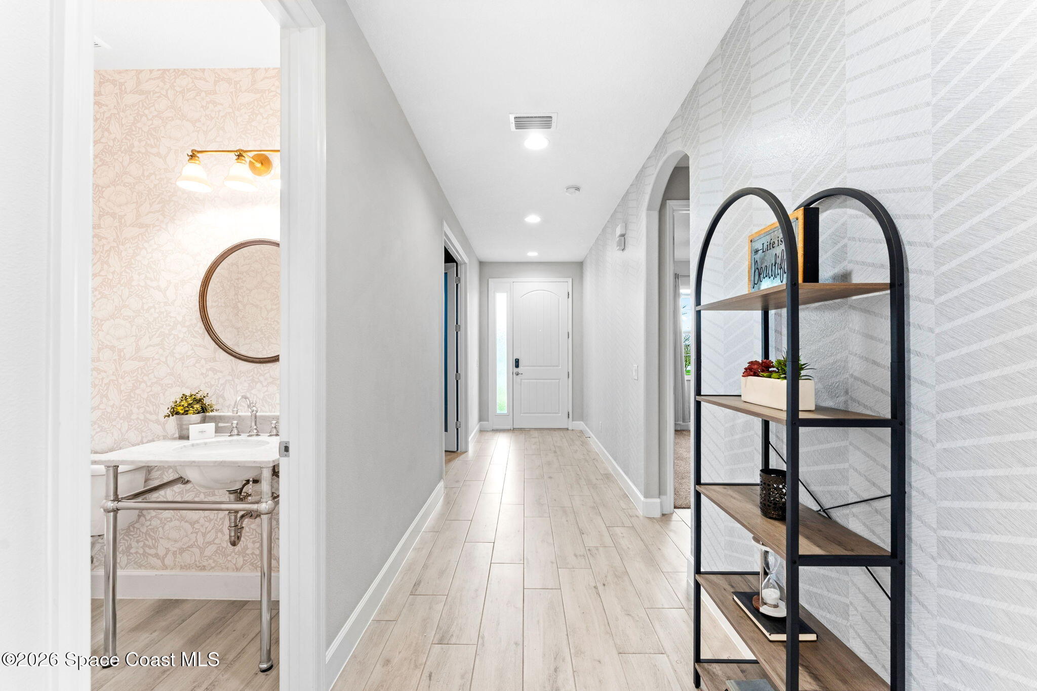 3158 Addison Drive Melbourne, FL 32940 - Photo 32 of 51 a view of a hallway with wooden floor and furniture