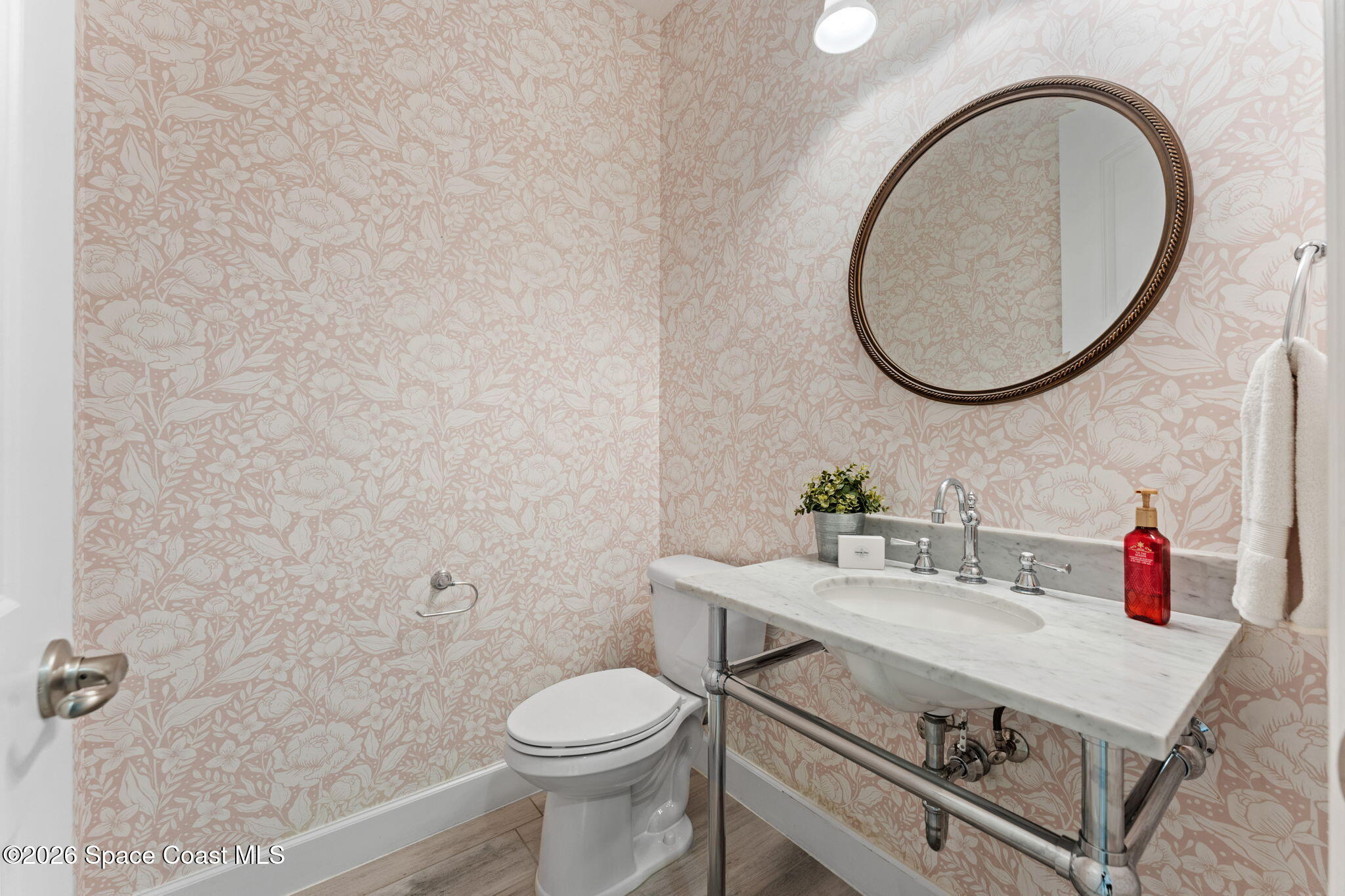 3158 Addison Drive Melbourne, FL 32940 - Photo 38 of 51 a bathroom with a sink a toilet and a mirror