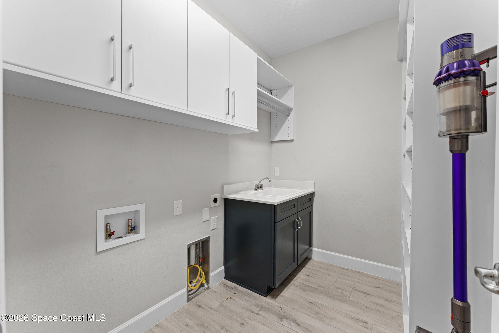 3158 Addison Drive Melbourne, FL 32940 - Photo 39 of 51 a utility room with cabinets