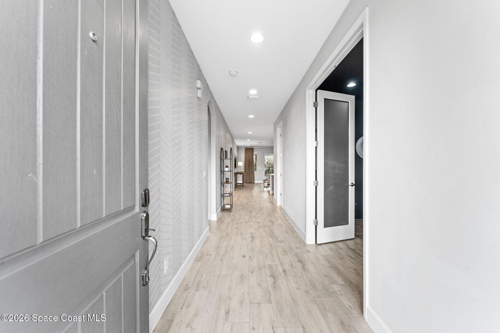 3158 Addison Drive Melbourne, FL 32940 - Photo 3 of 51 a view of a hallway with wooden floor