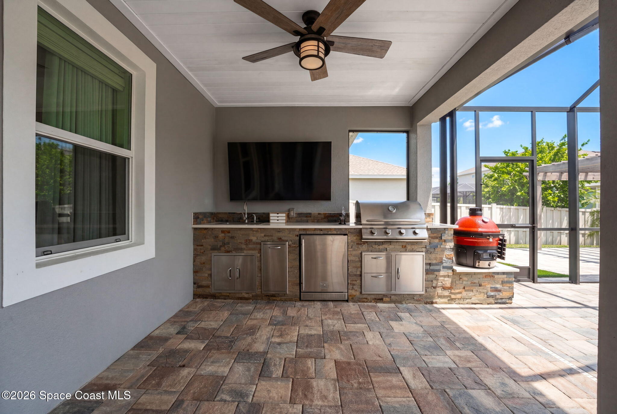 3158 Addison Drive Melbourne, FL 32940 - Photo 42 of 51 a kitchen with a stove a sink and a refrigerator