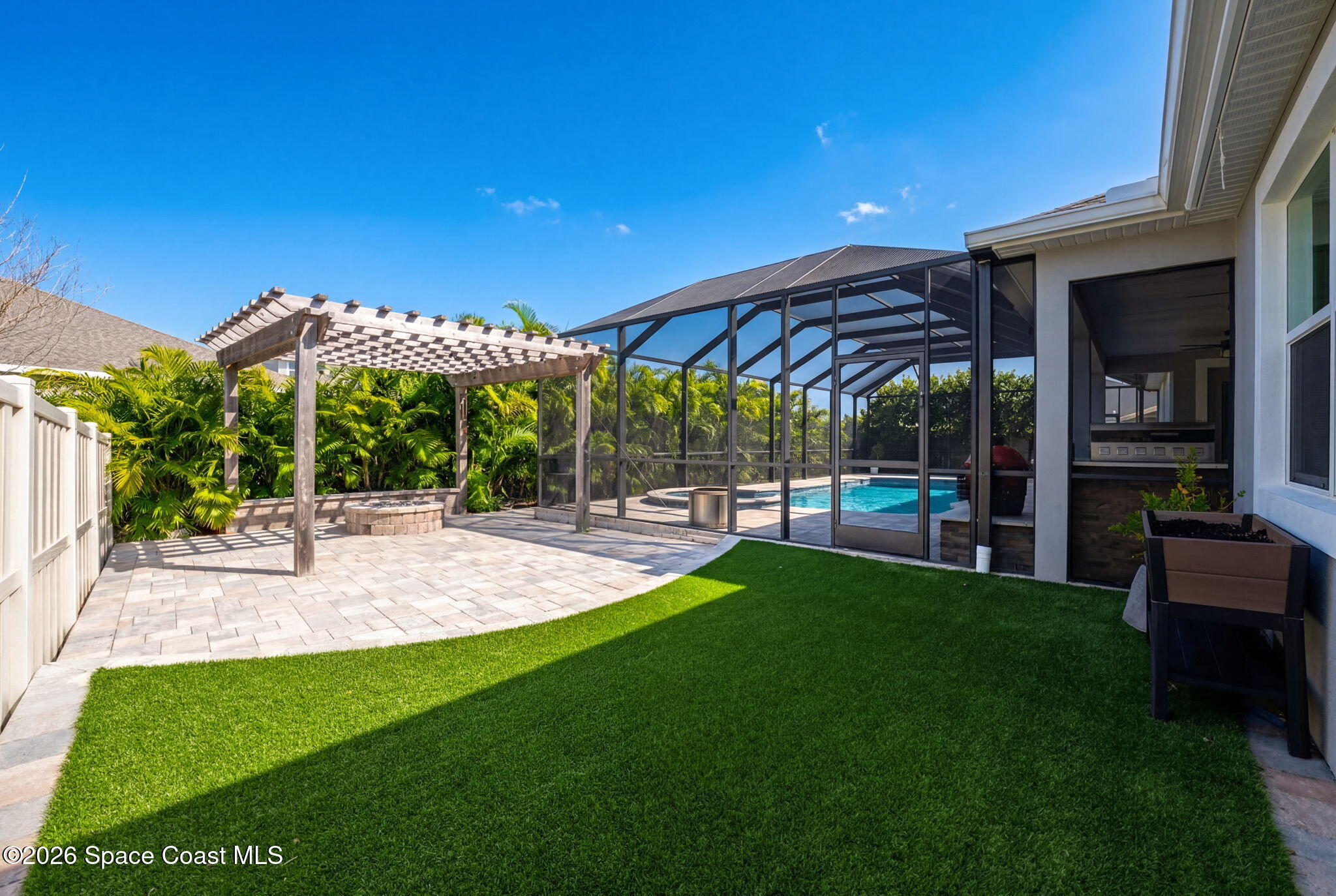 3158 Addison Drive Melbourne, FL 32940 - Photo 47 of 51 a view of a patio with a table and chairs under an umbrella