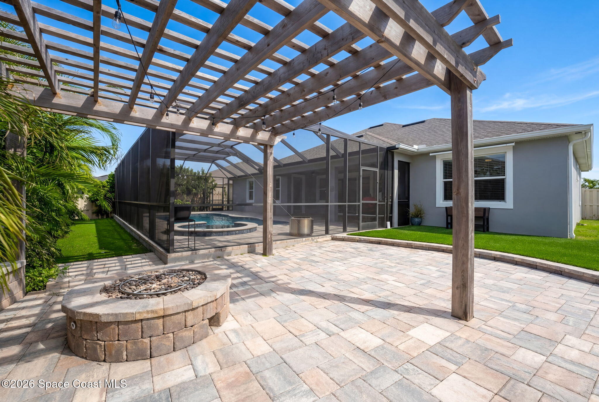 3158 Addison Drive Melbourne, FL 32940 - Photo 48 of 51 a view of a backyard with table and chairs potted plants and floor to ceiling window