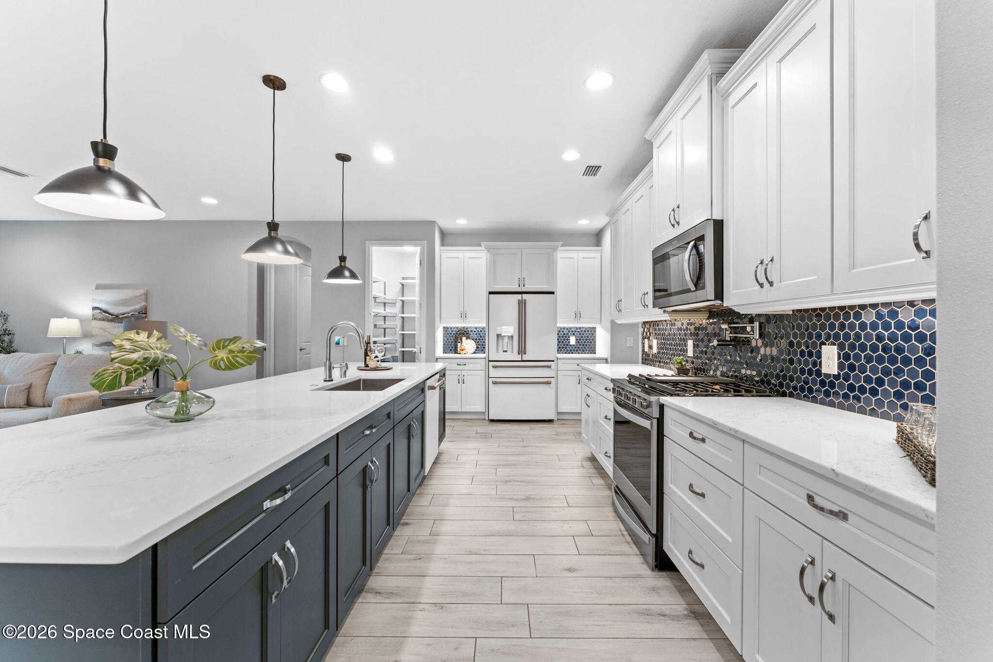 3158 Addison Drive Melbourne, FL 32940 - Photo 5 of 51 a kitchen with kitchen island granite countertop a sink a counter space appliances and cabinets