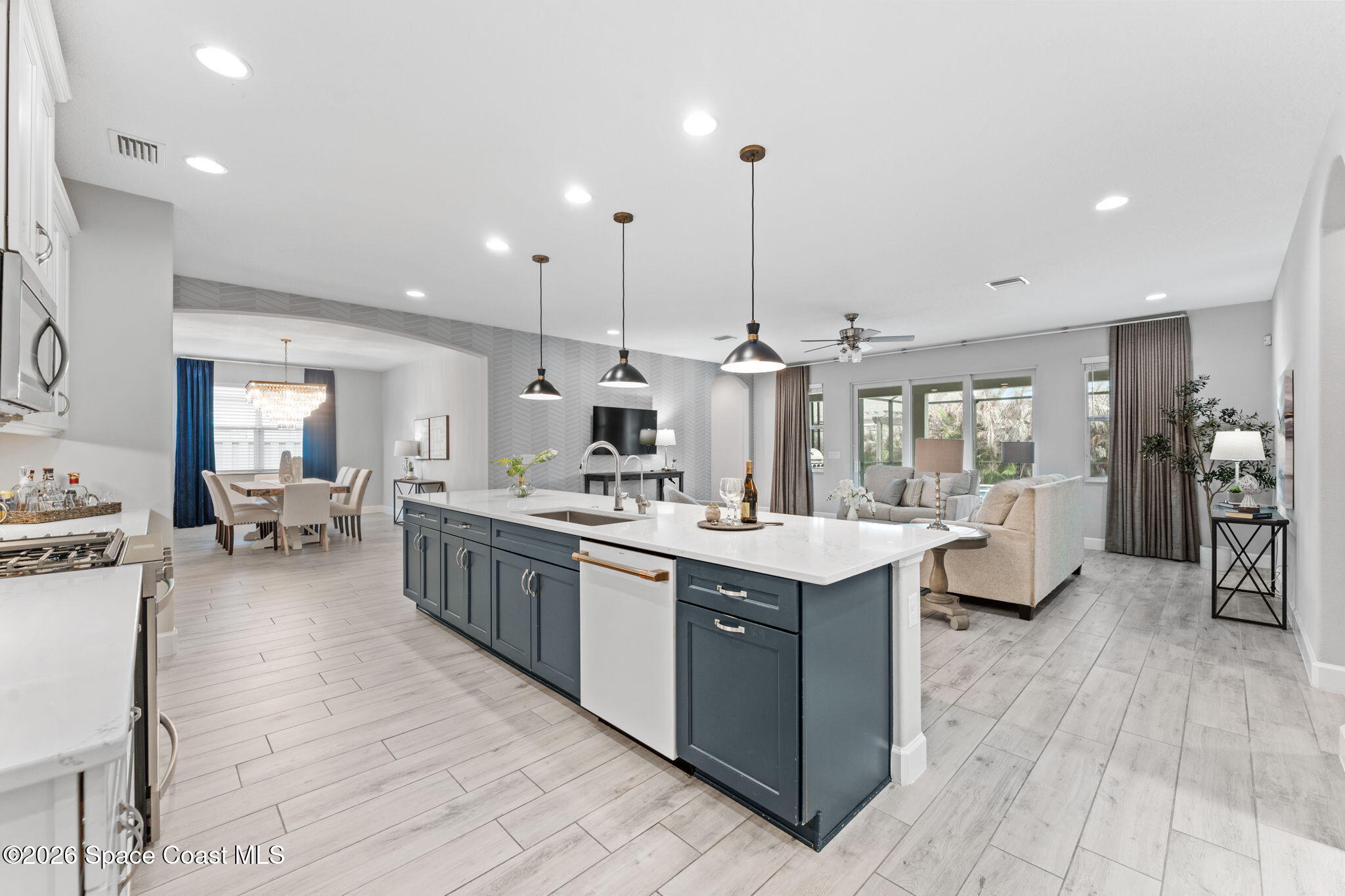 3158 Addison Drive Melbourne, FL 32940 - Photo 7 of 51 a large kitchen with kitchen island a stove a sink a center island in the center