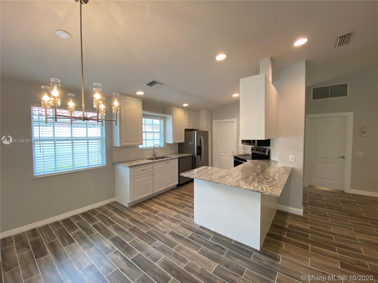 882 Southwest Balmoral Trace Stuart, FL 34997 - Photo 5 of 17 kitchen with adjacent dining area.