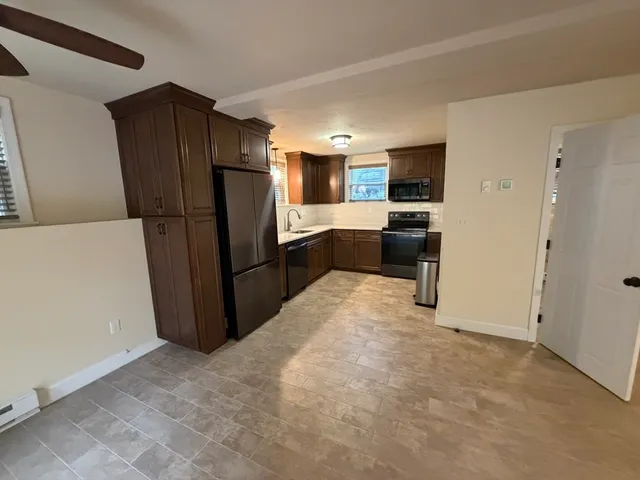 a kitchen with a refrigerator and a sink