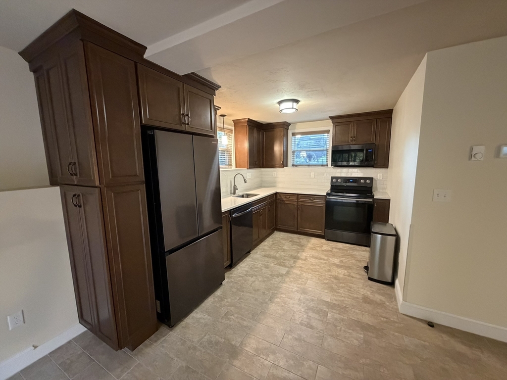 90 High Street, Unit 2 Mansfield, MA 02048 - Photo 2 of 20 a kitchen with stainless steel appliances a refrigerator and a stove