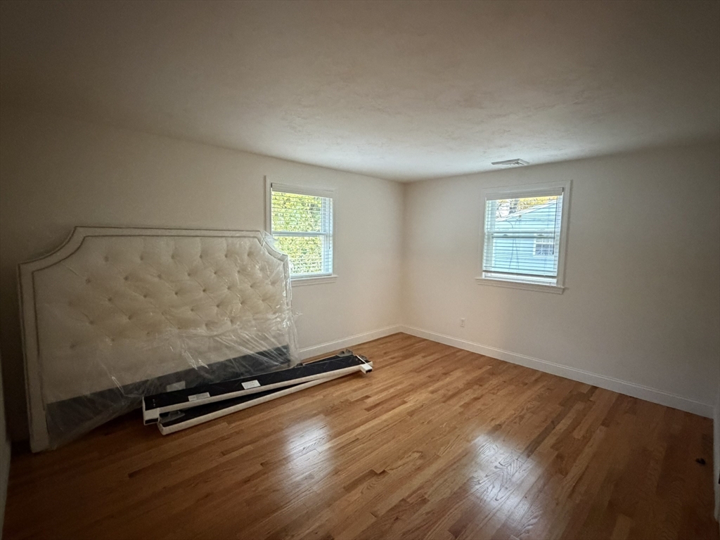90 High Street, Unit 2 Mansfield, MA 02048 - Photo 6 of 20 an empty room with wooden floor and windows