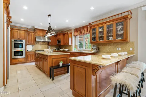 a kitchen with stainless steel appliances granite countertop a stove and a refrigerator