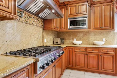 a kitchen with stainless steel appliances granite countertop a stove and a sink