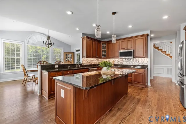 a living room with furniture a flat screen tv and a floor to ceiling window