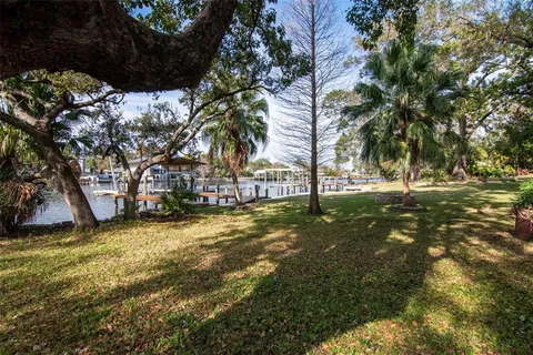 a view of swimming pool with a bench and trees