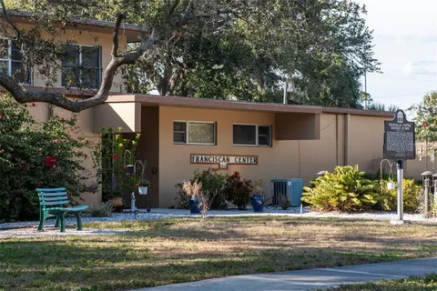 a front view of a house with a yard table and chairs
