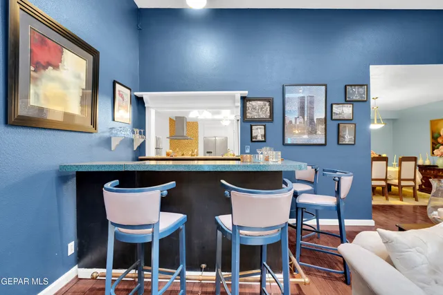 a dining room with furniture a large window and wooden floor