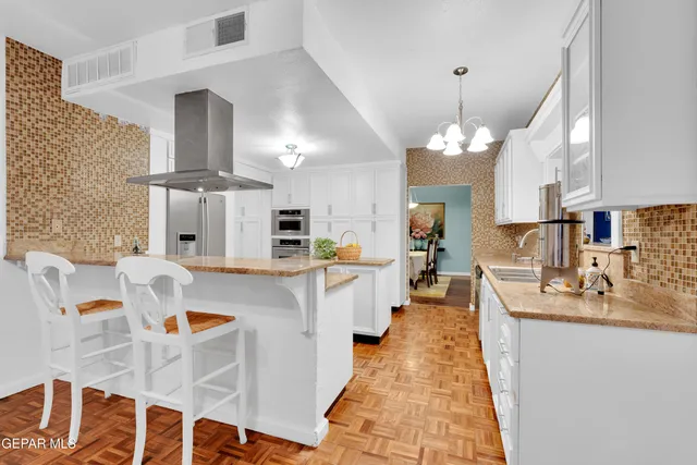 a large kitchen with a table and chairs