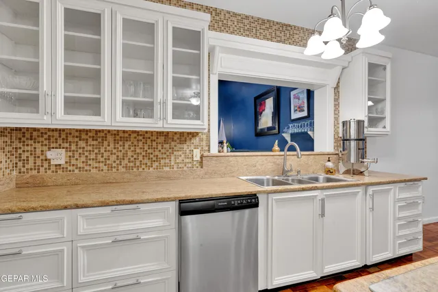 a kitchen with a sink vanity and a granite counter top