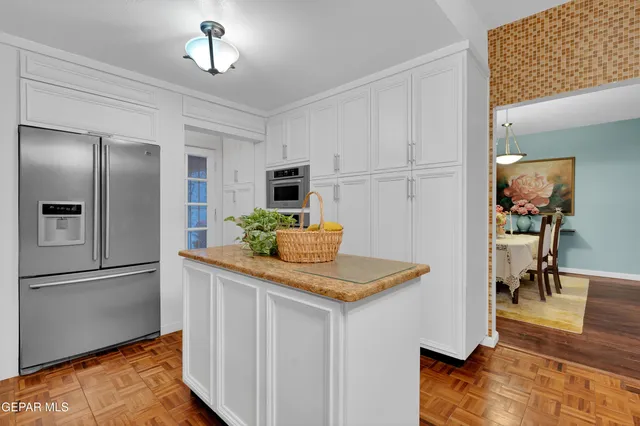 a kitchen with stainless steel appliances granite countertop a refrigerator and a stove