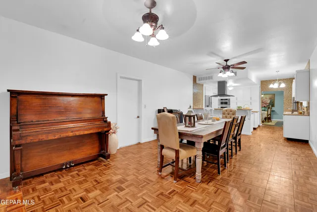 a view of a dining room with furniture and a chandelier