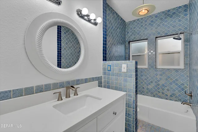 a bathroom with a sink a vanity and a mirror