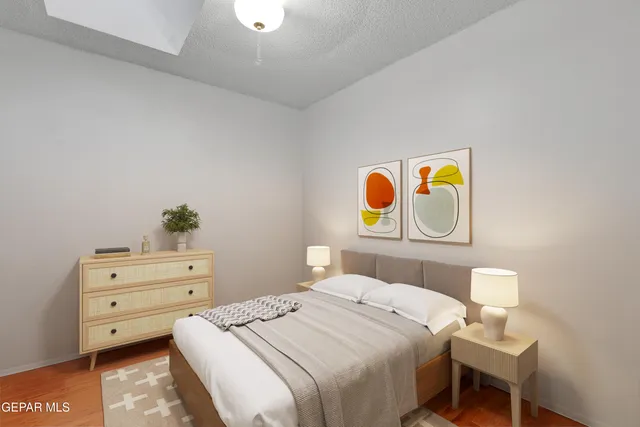 a bedroom with a bed and a dresser