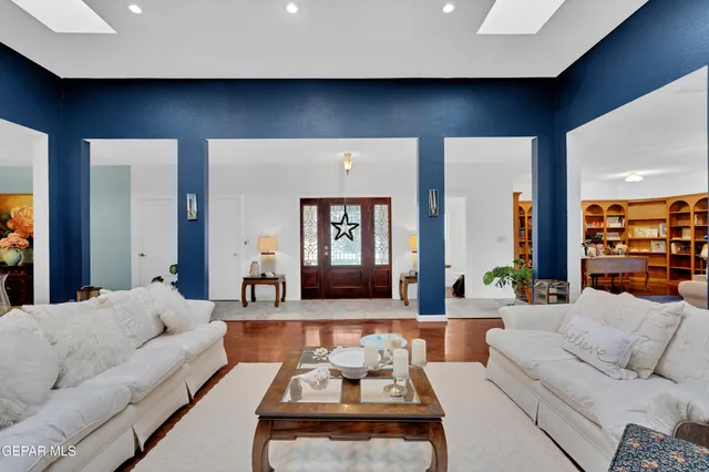 a living room with furniture and view of kitchen
