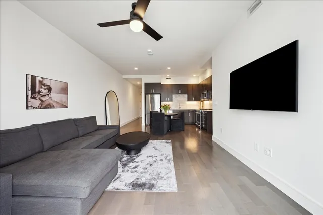 a living room with fireplace furniture and a flat screen tv