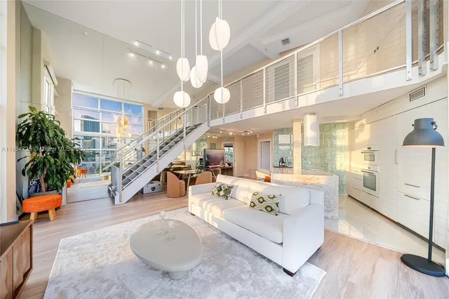 a living room with patio furniture and a large window