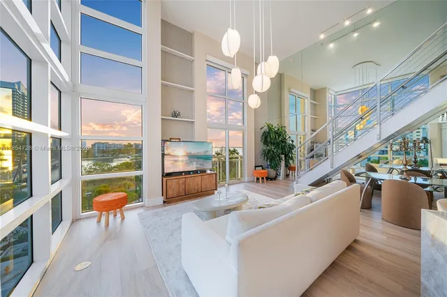 a lobby with furniture and floor to ceiling windows