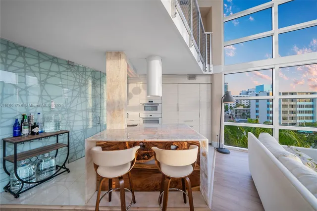 a dining room with furniture and a floor to ceiling window