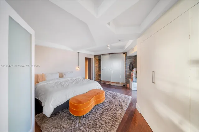 a bedroom with a bed and dresser