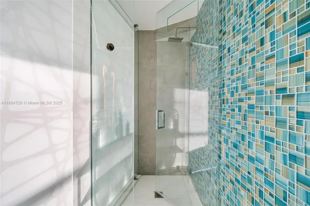 a bathroom with a shower and a sink