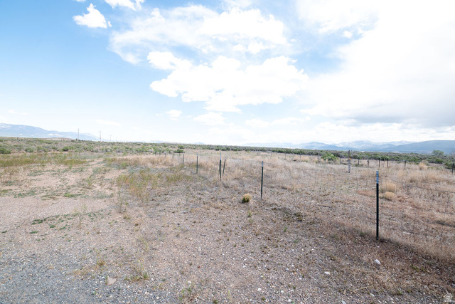 570 West Main Street Beaver, UT 84713 - Photo 36 of 43 Expansive undeveloped land featuring a wire fence, natural vegetation, distant mountains, and an open sky