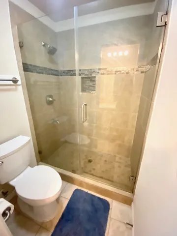 a bathroom with a toilet and a shower