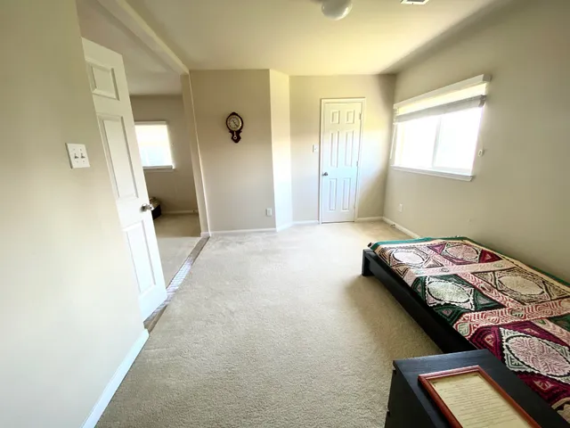 a bed room with a bed and a window