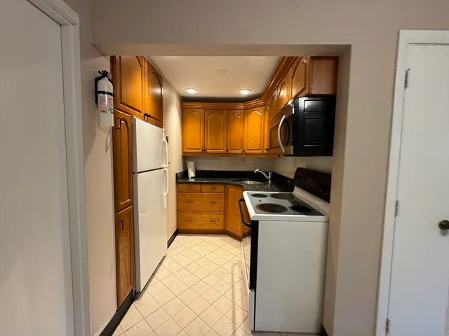 a kitchen with a refrigerator and a sink