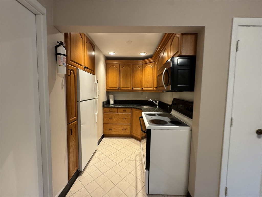 29 Arlington Road, Unit 2 Woburn, MA 01801 - Photo 2 of 11 a kitchen with a refrigerator and a sink
