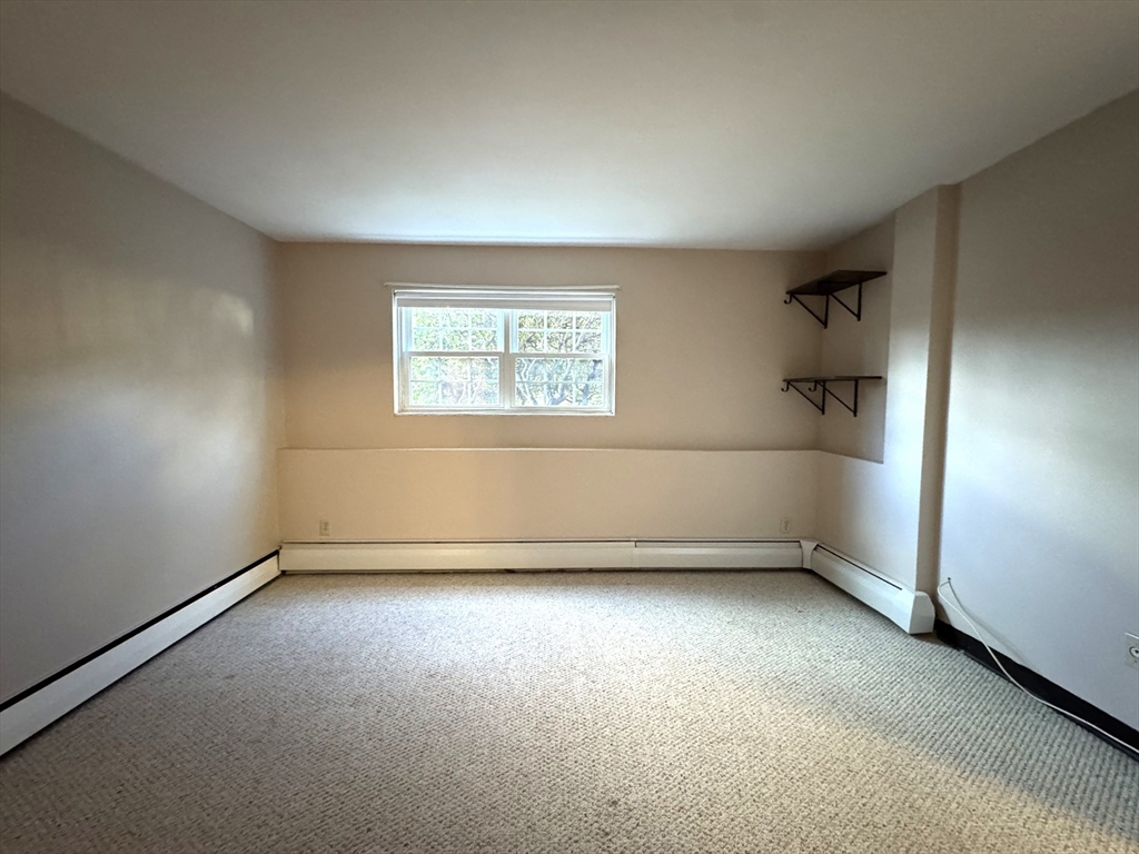 29 Arlington Road, Unit 2 Woburn, MA 01801 - Photo 6 of 11 an empty room with a empty space and windows