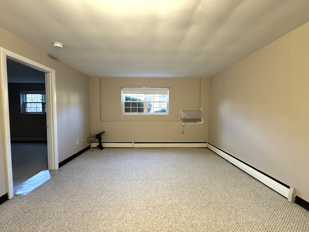 29 Arlington Road, Unit 2 Woburn, MA 01801 - Photo 7 of 11 an empty room with windows
