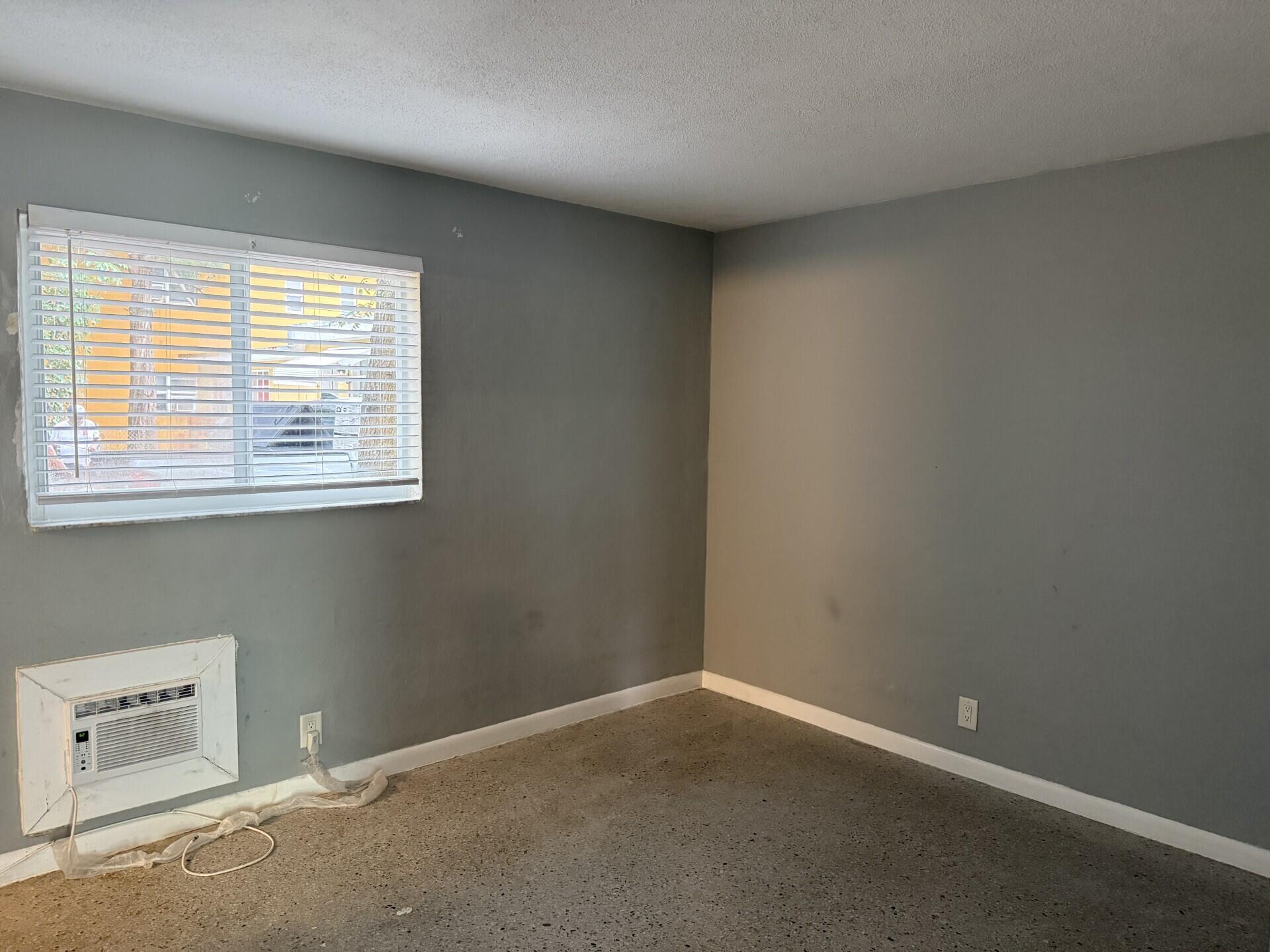 1118 North H Street, Unit 3 Lake Worth Beach, FL 33460 - Photo 4 of 11 an empty room with a window