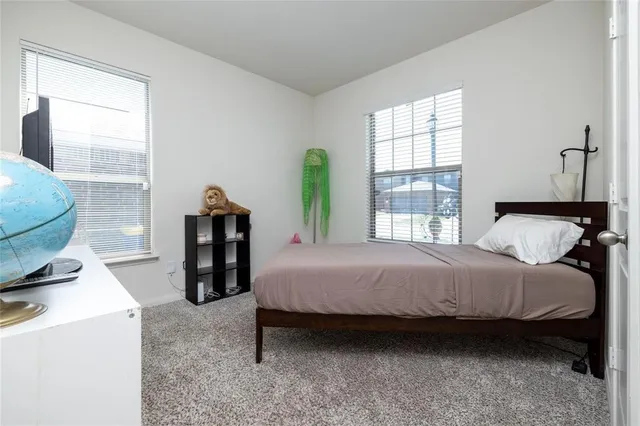 a bedroom with toys and a window