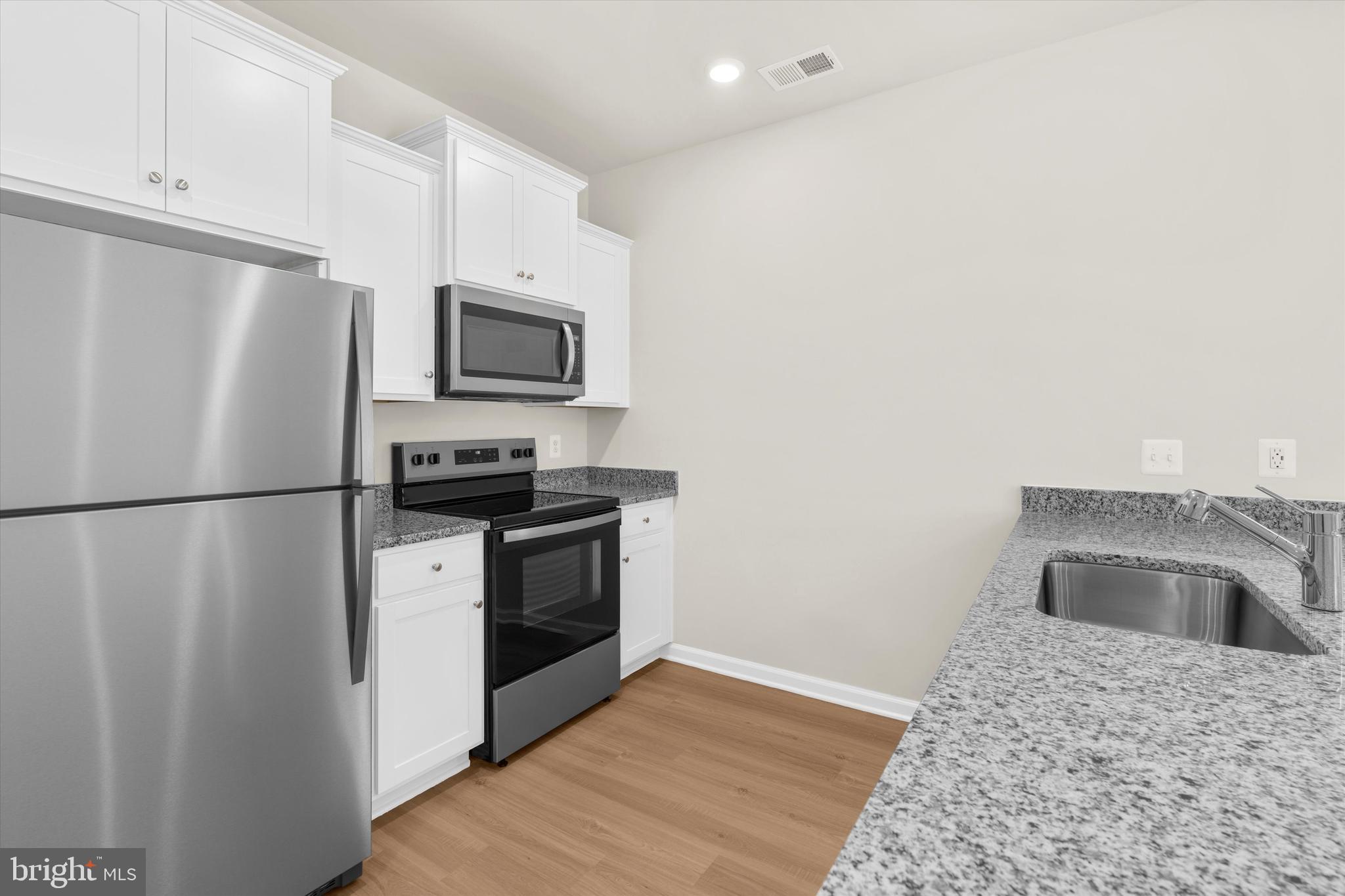8135 Bartholomew Court Baltimore, MD 21206 - Photo 27 of 46 a kitchen with a refrigerator sink and stove