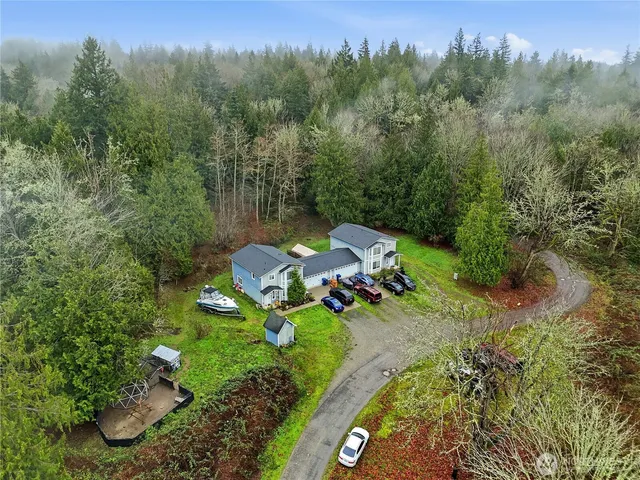 an aerial view of a house with a yard