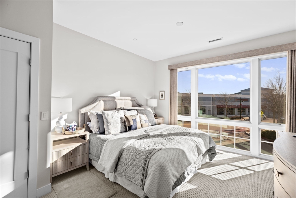 10 Shipyard Drive, Unit 215 Hingham, MA 02043 - Photo 13 of 18 a bedroom with a bed and a large window