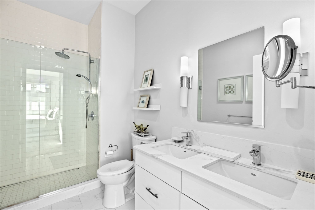 10 Shipyard Drive, Unit 215 Hingham, MA 02043 - Photo 15 of 18 a bathroom with a toilet sink and mirror