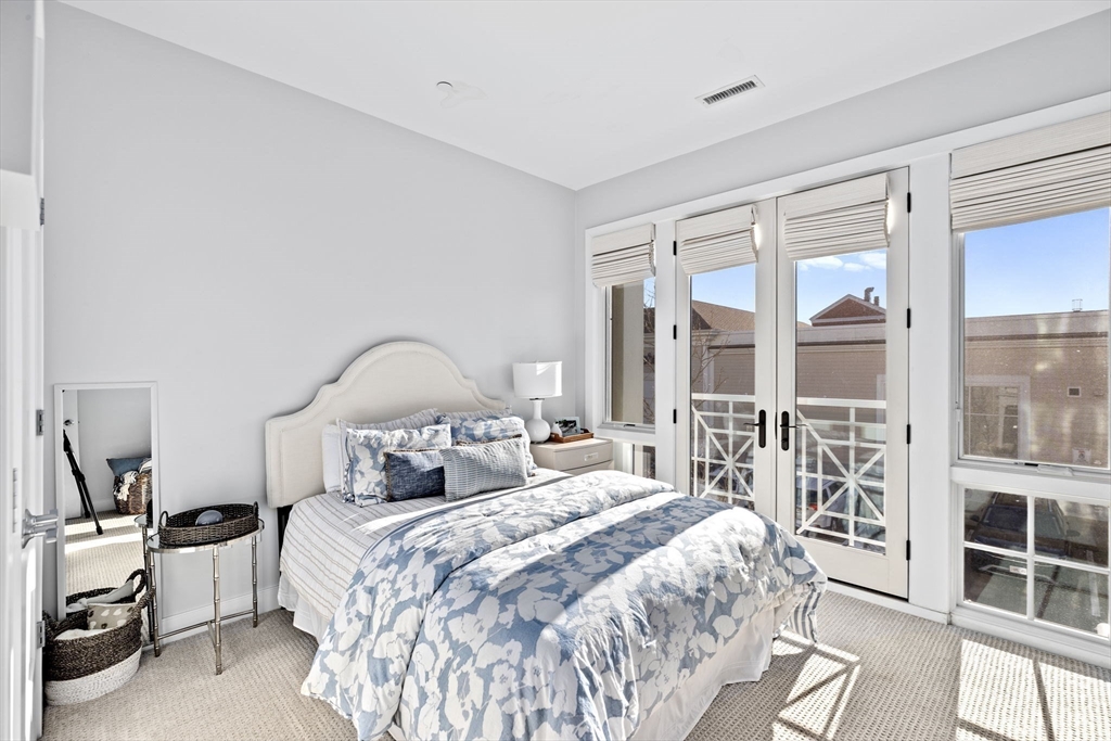 10 Shipyard Drive, Unit 215 Hingham, MA 02043 - Photo 17 of 18 a bedroom with a bed and a large window