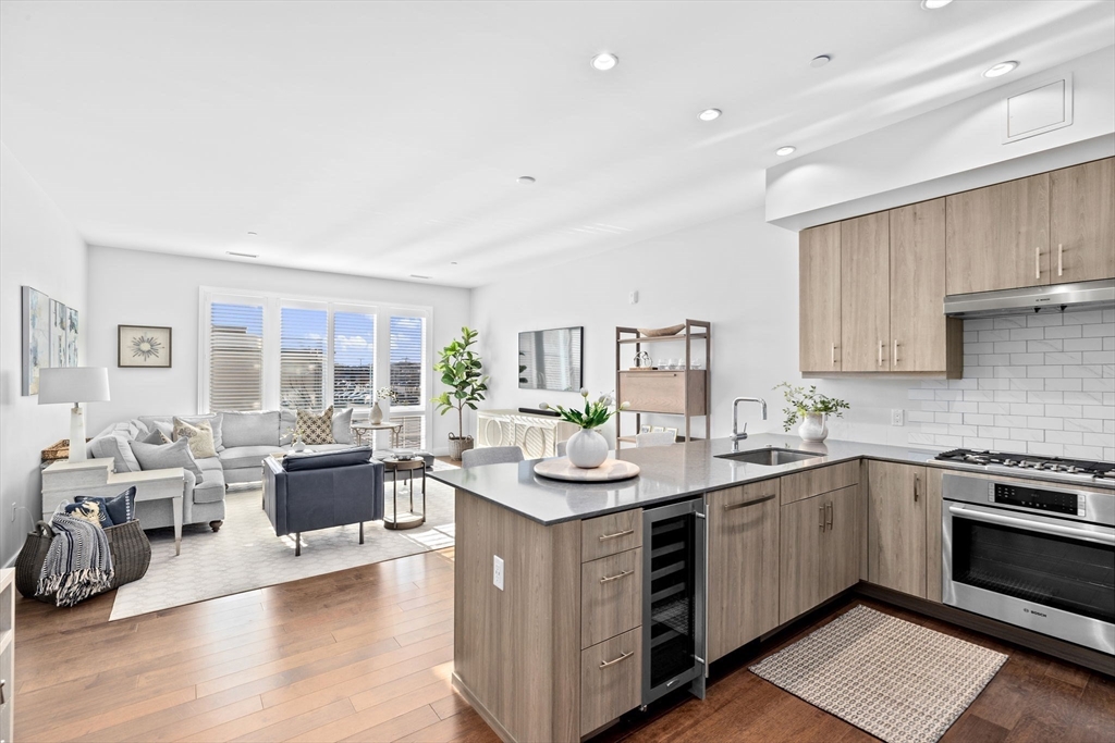 10 Shipyard Drive, Unit 215 Hingham, MA 02043 - Photo 4 of 18 a kitchen with a sink stove and cabinets