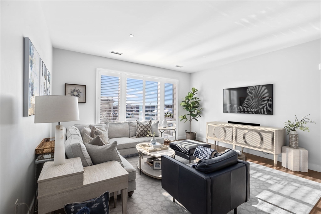 10 Shipyard Drive, Unit 215 Hingham, MA 02043 - Photo 6 of 18 a living room with furniture and a flat screen tv