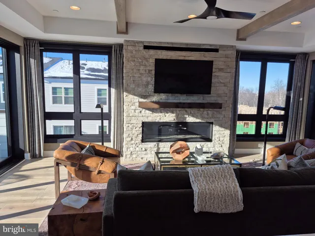 a living room with furniture fireplace and a flat screen tv